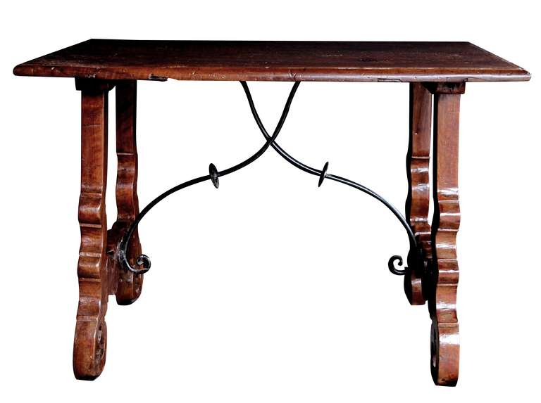 A Rustic Spanish Baroque Style Walnut Trestle Table with Iron Stretcher In Excellent Condition In San Francisco, CA