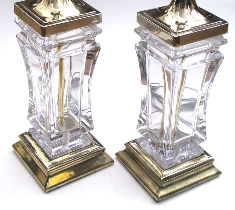 A good quality pair of French 1960's crystal lamps with brass fittings; labeled 'Cofrac, Paris, Made in France'; each thickly modeled crystal lamp of square form with waisted mid-section