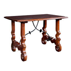 A Rustic Spanish Baroque Style Walnut Trestle Table with Iron Stretcher