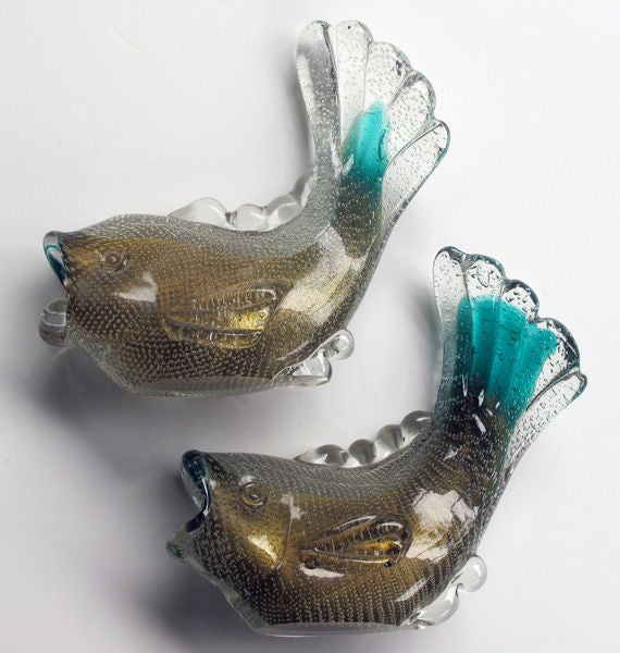 A good pair of Venetian 1950's gold polveri fish by Archimide Seguso; each stunningly fluid fish with gold powder and hints of turquoise glass within a clear glass outer layer with controlled bubbles
