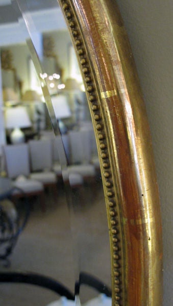 19th Century Elegant French Napoleon III Oval Giltwood Mirror with Exuberant Ribbon Crest