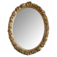 A Finely-Carved French Louis XVI Style Oval Giltwood Mirror