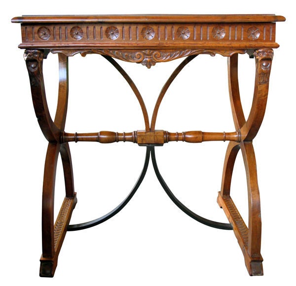 A Handsome Italian Renaissance Revival Carved Walnut Side Table with Curved Iron Stretcher