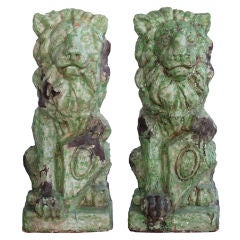A Regal Pair of French Baroque Style Pale-Green Glazed Terra Cotta Seated Lions