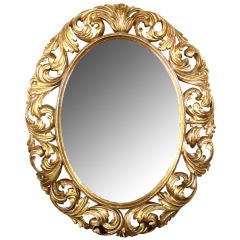A Well-Carved Italian Baroque Style Oval Giltwood Mirror