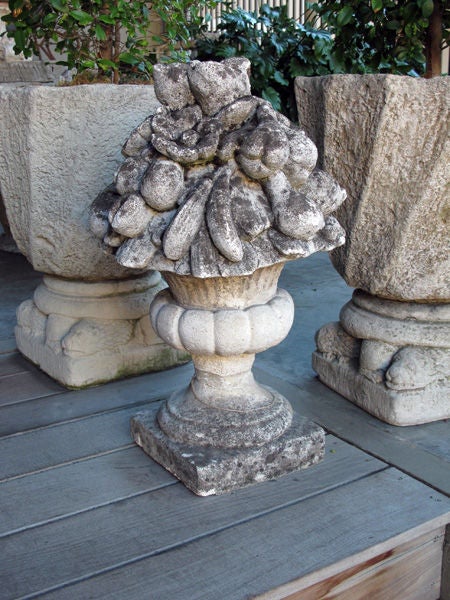 A lush English cast stone floral and fruit-filled garden urn; the splayed campagna urn filled with a luxuriant display of plump fruit and robust flower heads