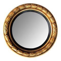 A Boldly-Rendered English Giltwood Convex Bulls-Eye Mirror