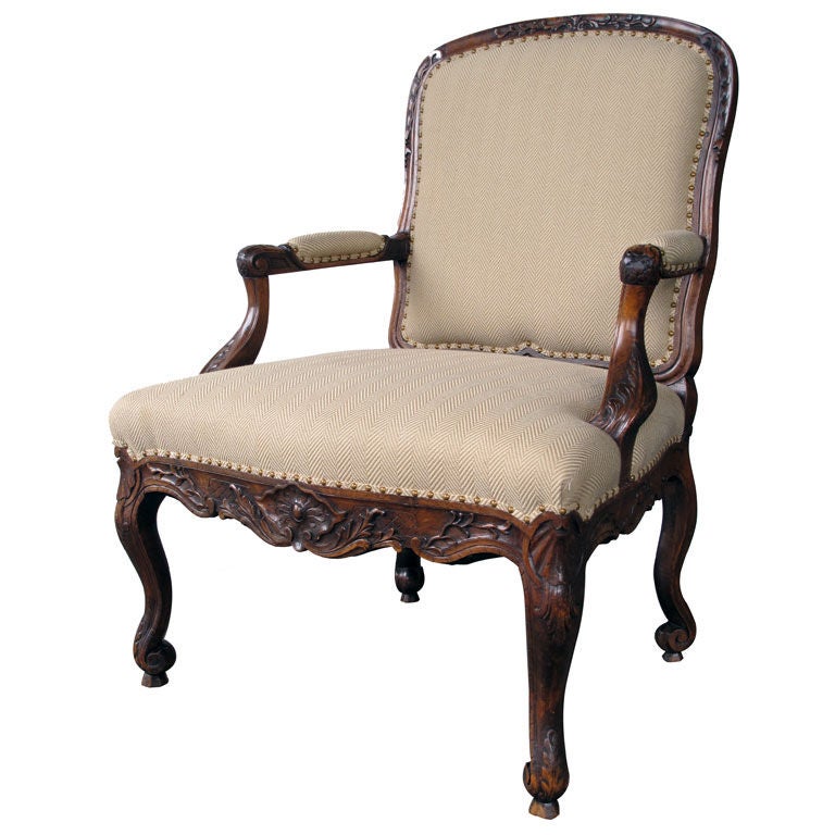 A Curvaceous Danish Rococo Style Carved Walnut Open Armchair For Sale