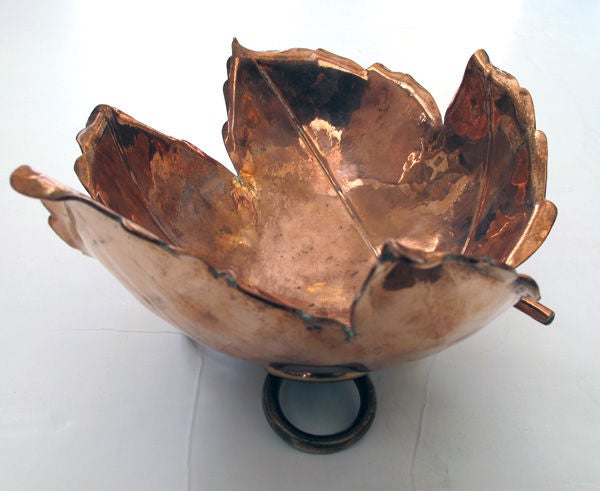 A beautifully rendered American hand-wrought copper maple leaf-form bowl by Alfredo Sciarrotta b. 1907 d. 1985; stamped: 'Sciarrotta handmade, Newport RI'; the well-crafted leaf of thick copper with fine veining and curled edges raised on a cluster