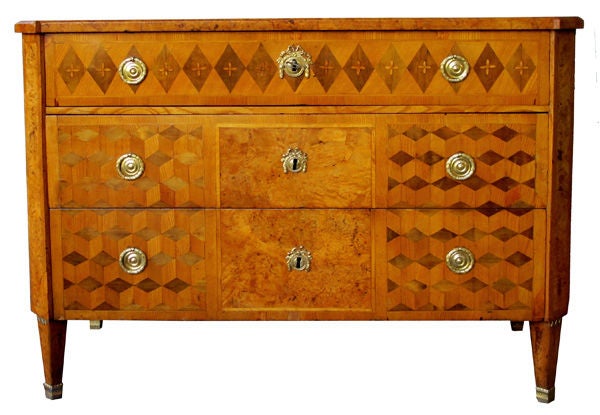 A handsome Swedish Gustavian alder root parquetry 3-drawer chest; the well-figured top with canted corners above a body fitted with 3 graduated drawers with parquetry veneer; raised on tapering quadrangular supports with gilt-bronze mounts