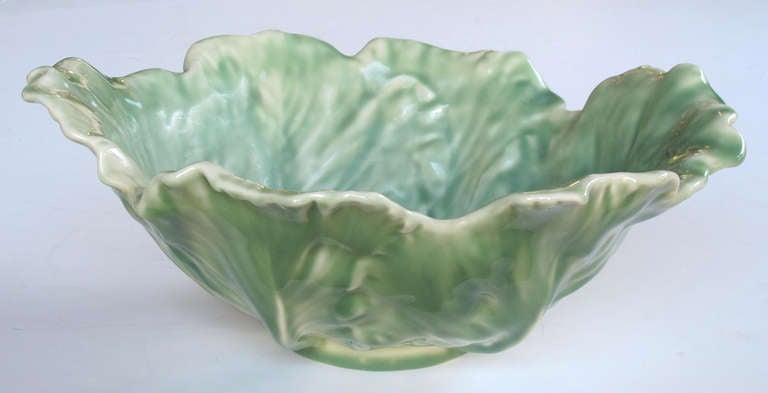 A boldly-scaled American Rookwood Art pottery pale-green glazed cabbage-leaf bowl; impressed Rookwood mark and date XLVII (1947); the well-detailed deep bowl depicting large overlapping cabbage leaves with flared undulating rim all tapering to a