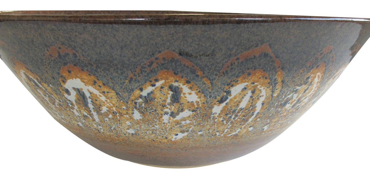 A massive and well-modeled American studio pottery bowl; signed '1980 Heard Museum Clay Demonstration; Phoenix, AZ'; the large bowl featuring stylized ochre leaves on a mottled slate blue ground