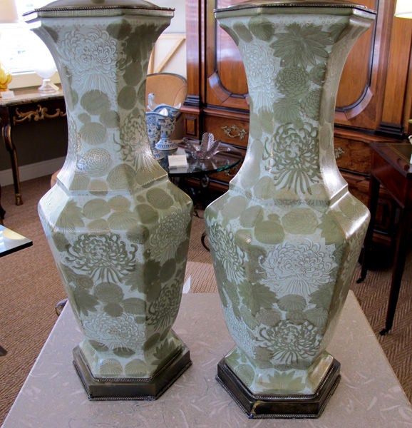 An elegant pair of American 1940s hexagonal baluster-form celadon polychromed ceramic vases with floral decoration; now mounted as lamps; by Frederick Cooper, Chicago; each hexagonal vase with flared neck above a bulbous body ending in a splayed