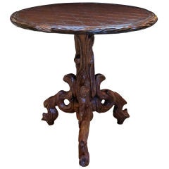 A Whimsical German Black Forest Carved Oak Circular Side Table