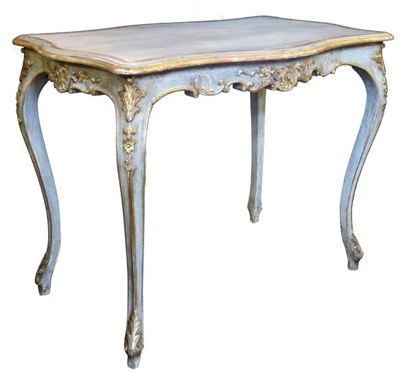 An elegant Swedish rococo style blue/gray painted and parcel-gilt rectangular side table; the top of arbalete form above a scalloped apron adorned with rocaille and floral carving; raised on graceful cabriole supports with acanthus leaves at the