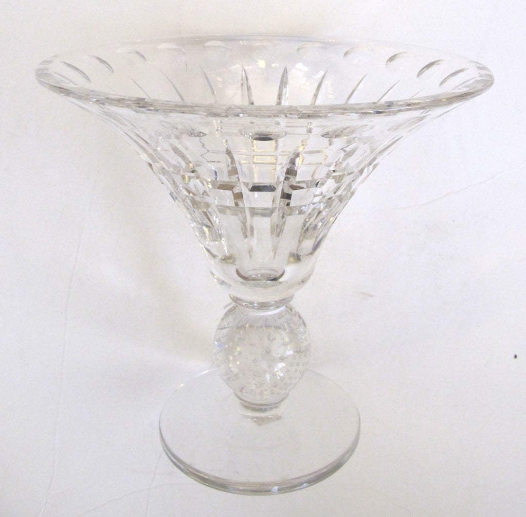 An elegant and good-quality American Pairpoint fluted cut-glass crystal compote with controlled bubble stem; the flared bowl with thumbprint edge above a cut-glass body; raised on a controlled bubble sphere all over a circular base