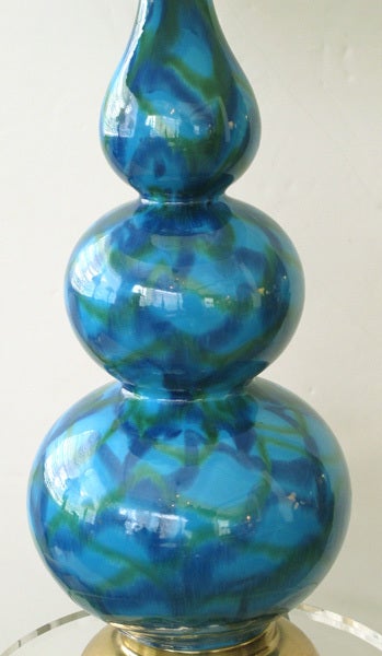 A shapely pair of American mid-century aqua glazed triple gourd ceramic lamps with green and lavendar highlights; each with long neck above a graduated triple gourd body all raised on a brass base