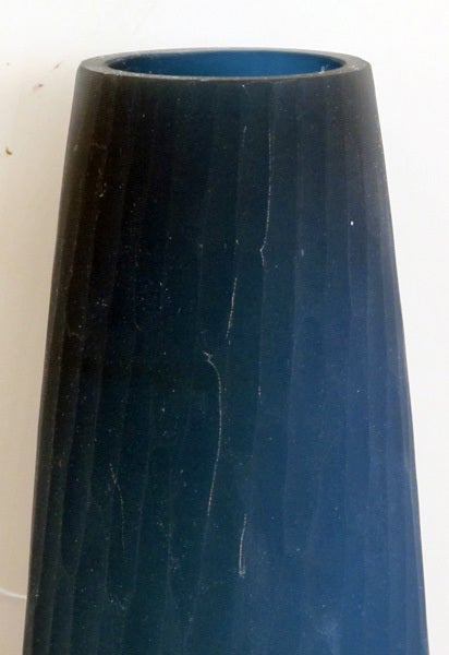 An elegantly-shaped pair of Swedish 1960's midnight-blue satin cased glass bullet vases; each tall gently bulging vase of translucent midnight blue frosted glass with hand carved textured surface