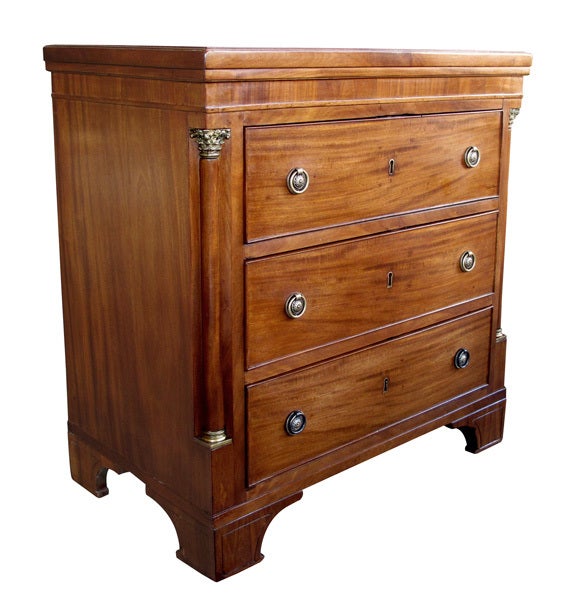 A handsome Danish neoclassical mahogany 3-drawer commode with bronze mounts; the rectangular top above a conforming base fitted with 3 drawers flanked by corinthian columns with bronze mounts; raised on bracket feet