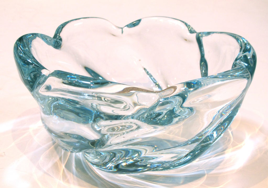 A shimmering Swedish 1940's Orrefors aqua crystal lobed bowl; by Edvin Ohstrom; signed 'Orrefors 2611'; the large-scaled heavily modeled bowl with scalloped rim above a thick body of swirling glass