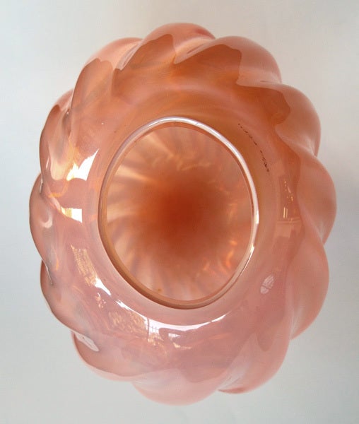 A good quality Murano mid-century ovoid ribbed vase of translucent pink glass by Seguso; the ovoid vase with pronounced spiraling ribs tapering to the base