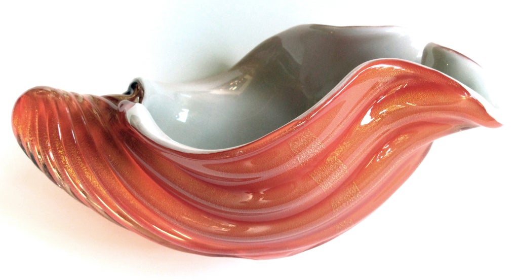 A large-scaled Murano mid-century burnt-orange glass and gold aventurine sea shell with white interior; the white interior with scalloped edge with a ribbed out 'shell' of clear cased glass with gold inclusions over burnt-orange