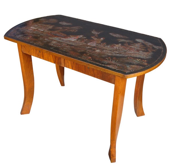 An unusual Austrian secessionist walnut veneered 2-drawer center table with chinoiserie top; the rectangular top with bowed ends adorned with a tranquil chinoiserie landscape; above an apron fitted with 2 drawers with finished back; raised on