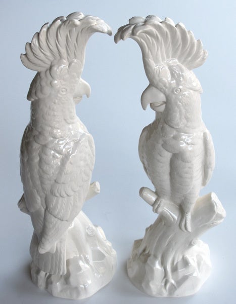 A large and striking pair of English Minton porcelain cockatoo figurines; with Minton mark and signed '18th Cent., Staffordshire Salt-Glaze'; each alert cockatoo perched on a branch with showy crest and curved bill all over a rockwork base