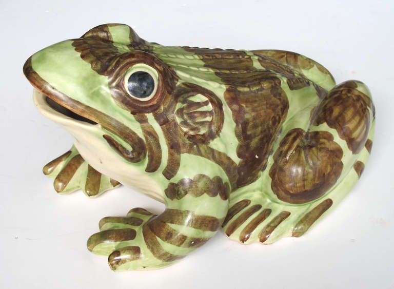 An exceptionally large American 1930's hand-painted ceramic garden frog by Brush McCoy; the compact molded frog with textured back; bulging black-accented eyes and open mouth; painted with brown accents on a celery-green ground