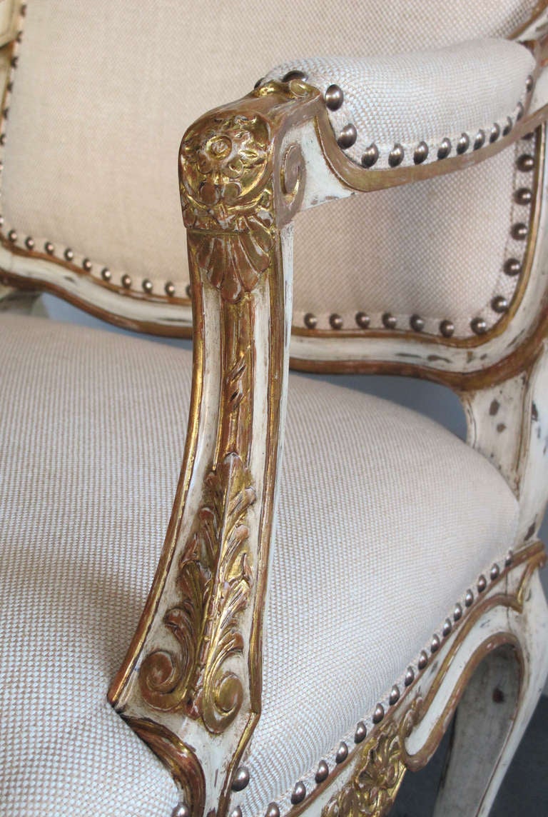 A Handsome Pair of French Louis XV Style Ivory Painted & Parcel-Gilt Arm Chairs 1