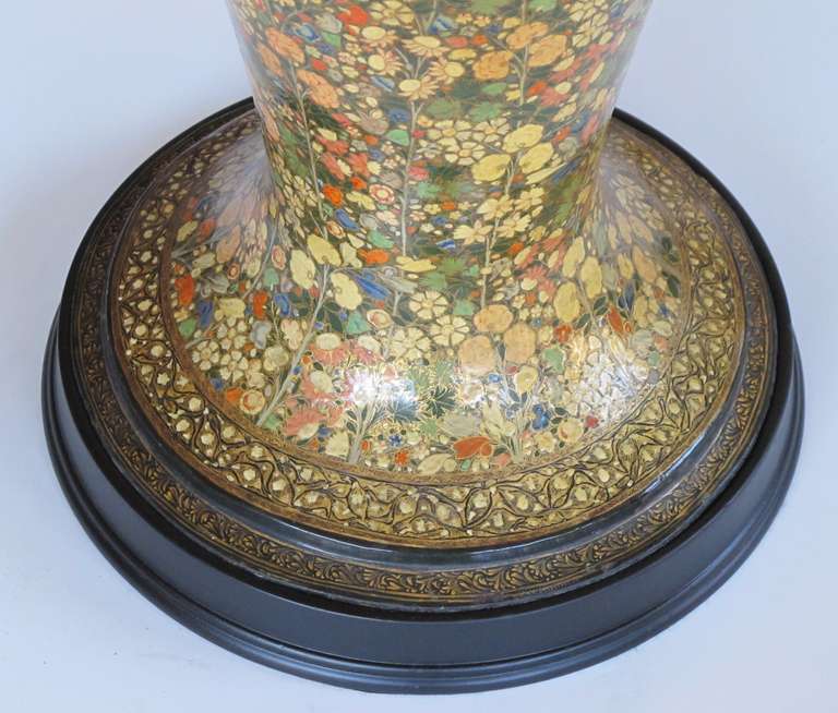 A monumental and good quality Kashmiri polychromed mille fleur lacquered urn now mounted as a lamp; of ovoid shape with flared foot and ebonized base; adorned overall with finely painted floral and foliate vines