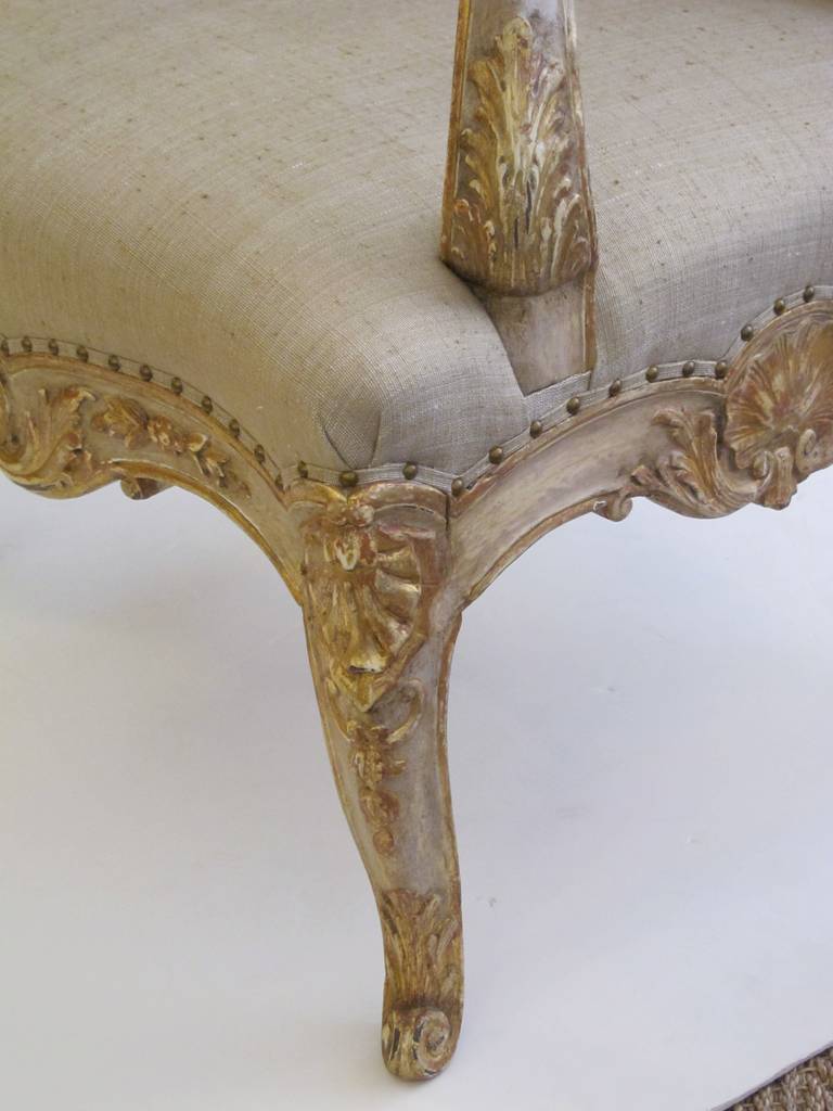 A Baronial French Regence Style Ivory Painted Open Armchair For Sale 1