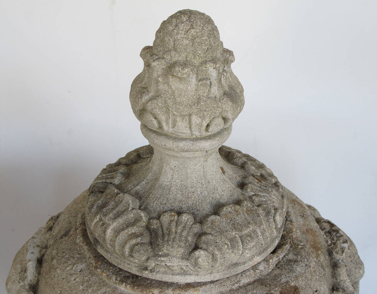 Early 20th Century Pair of English Cast Stone Urn-Form Finials with Swag and Ram's-Head Motif