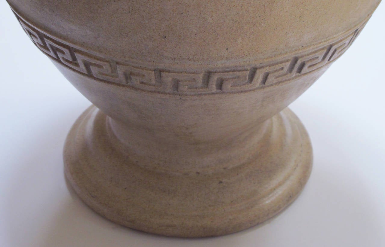 A handsome American neoclassical style pottery urn; by N. Clark & Sons, Alameda, California; with rolled lip above an ovoid body adorned with a Greek key perimeter band.