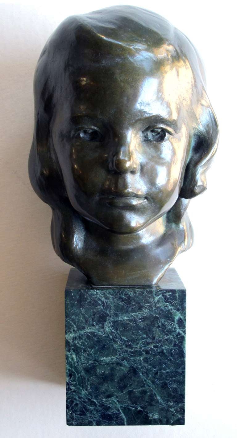 A beautifully rendered American 1940's bronze bust of a young girl on marble plinth; signed 'JG Kendall, Gorham Co. Founders'; the richly-patinated bust of young girl with serene direct gaze and soft wavy hair; raised on a green marble plinth