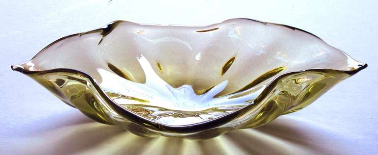 A large and good quality Murano 1960's olive green art glass leaf-form bowl with gold inclusions; with foil label 'made by Alfredo Barbini, Murano'; the large gold aventurine bowl undulating rim and pinched ends