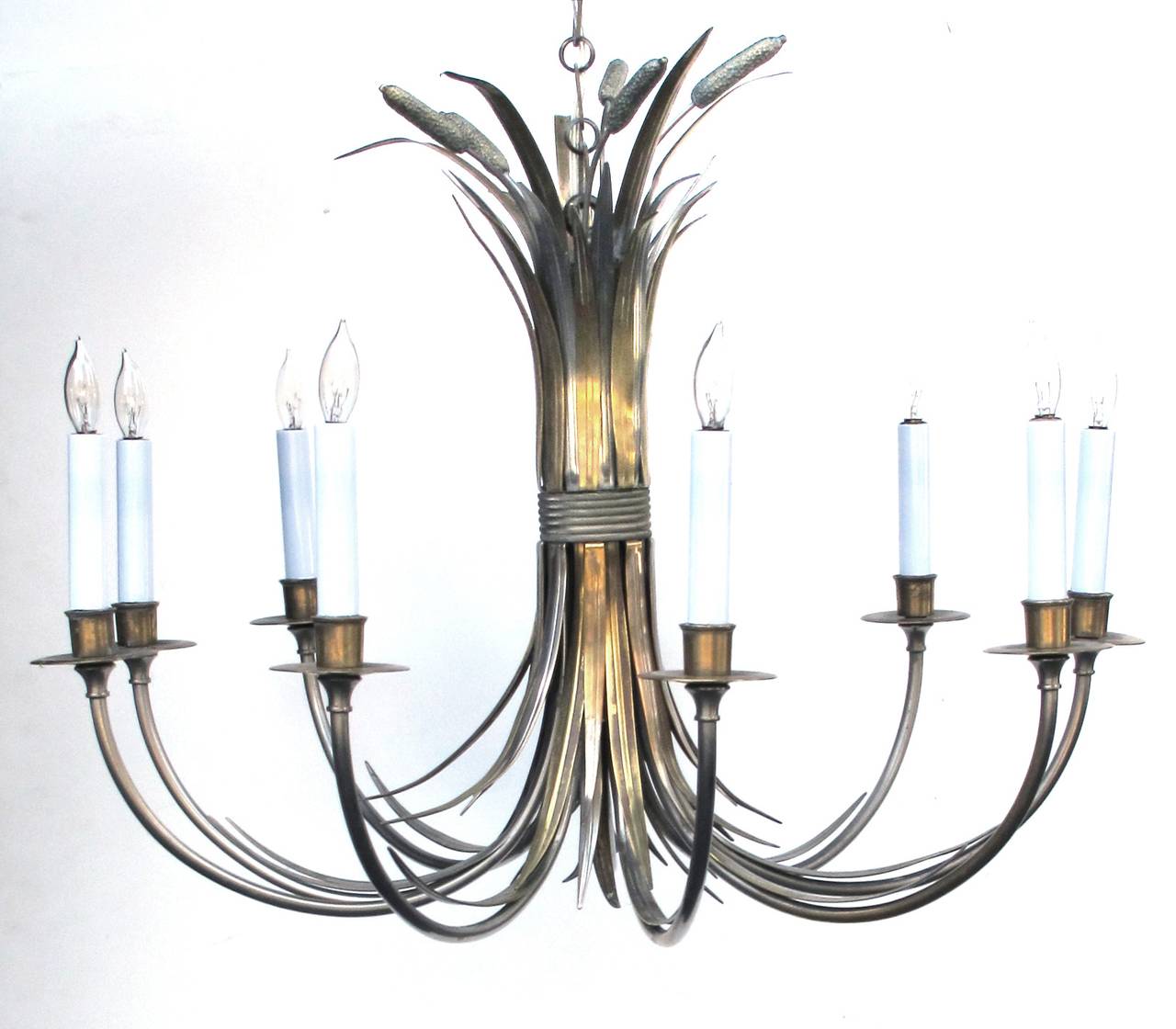 A stylish French Mid-Century nickel and brass nine-light chandelier of tied cattails by Maison Charles, Paris. The central shaft depicting bunched cattails with flat spikey leaves.