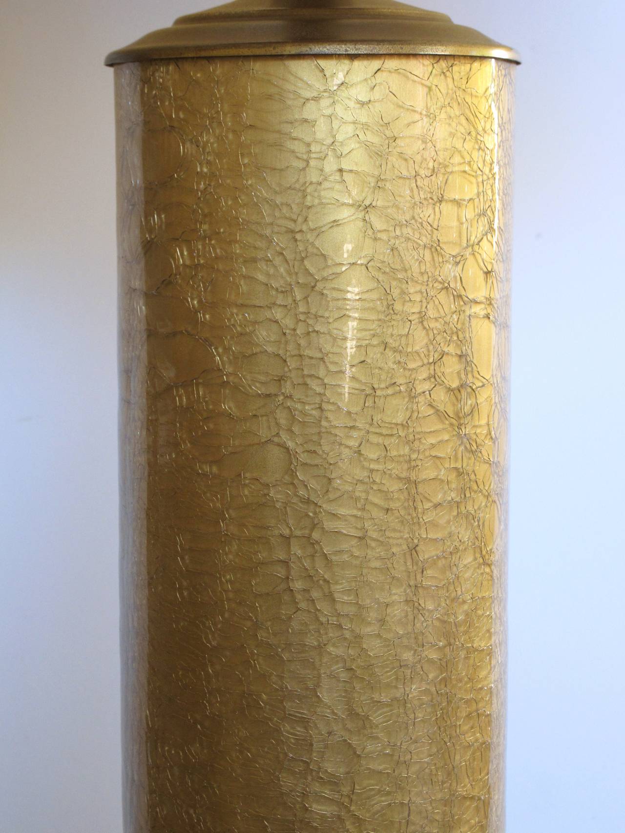 A stylish pair of American mid-century Hollywood regency cylindrical gold crack lamps designed by Paul Hanson for Oxford Lamp Co; each well-made cased-glass lamp of finely crackled gold glass; with label underside