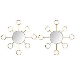 An Iconic Pair of 1960's Stylized Solid Brass Sunburst Mirrors