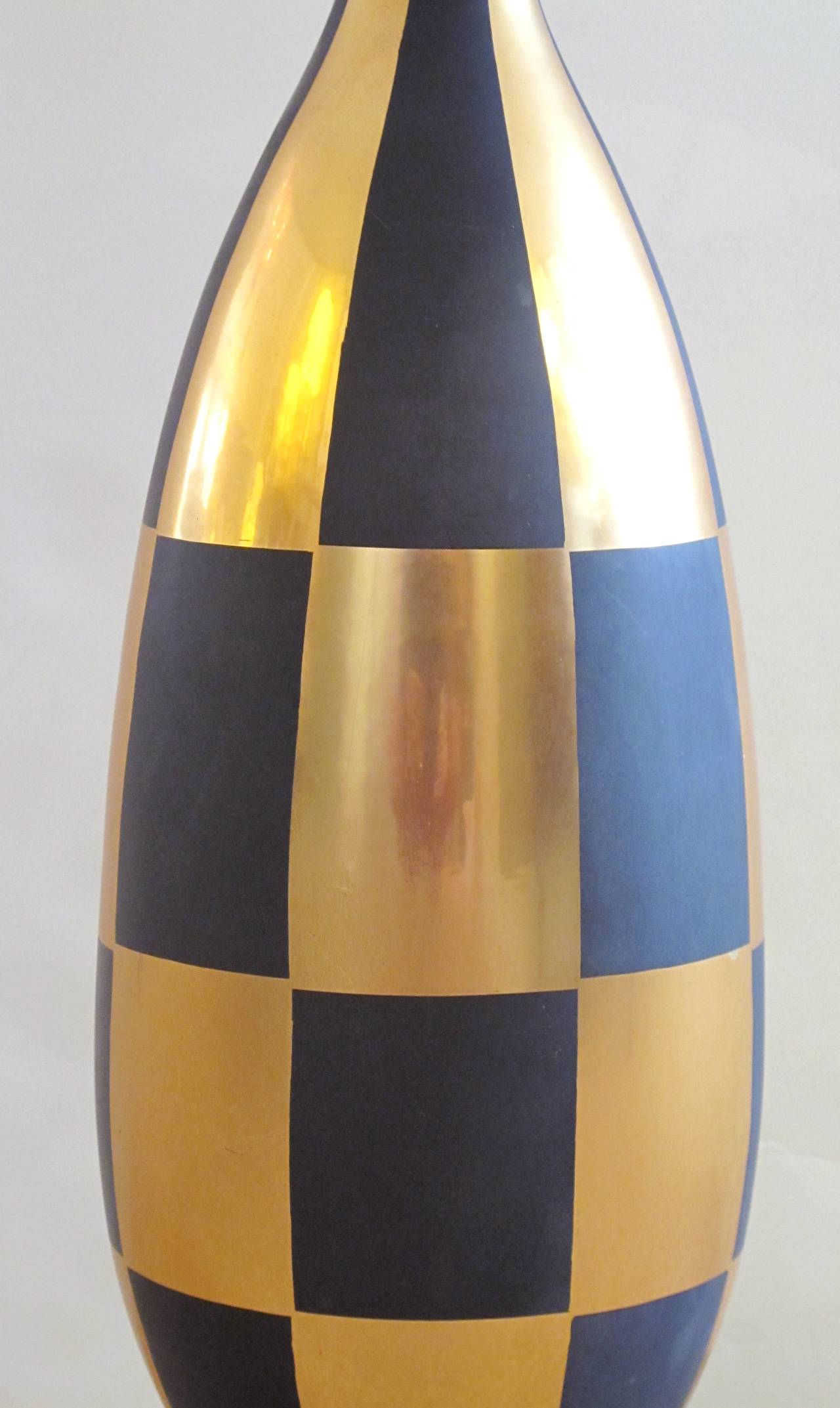 A stylish Italian 1960s gold and black porcelain lamp with harlequin design; of bulbous form with gilt and black harlequin design over an ebonized plinth.