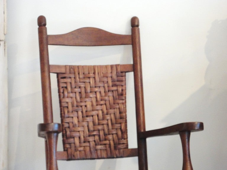 Full size oak and splint hickory woven seat and back rocking chair with matching foot stool in the same format.Sold as a two piece set.The two are in very good sturdy condition.The finish is a natural old varnish stain.Sold only as a pair.