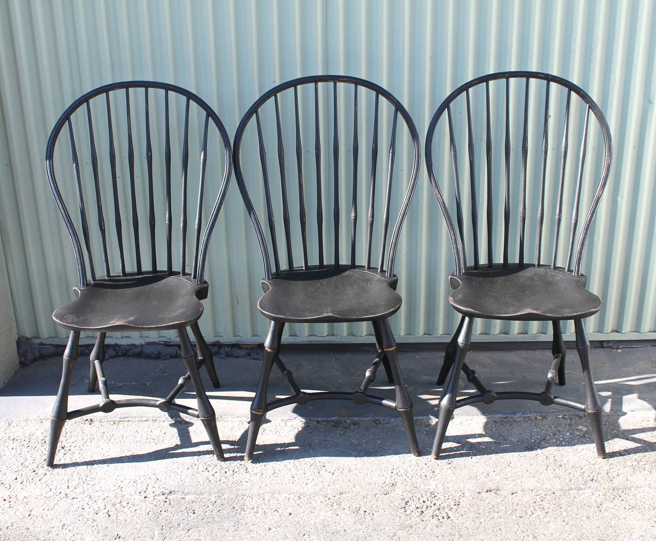 This wonderful set of three black painted exaggerated bow back Windsor chairs are in great condition and very sturdy. Not so difficult to find a fourth to make a set. This set is late 19th century and have wonderful form. They are very comfortable