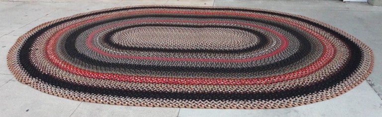 This is one of the most amazing large oval hand braided rugs we have ever owned.Wonderful southwestern colors and in great condition.It is orange,grey ,brown black,cream and rust and bittersweet.The size is great and the colors are wonderful.