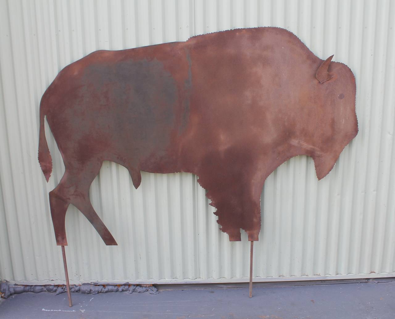 This large sheet iron buffalo came from a buffalo ranch in Texas. It is a handmade sign probably used for as stated. It has the original pokers for going right in the ground. It is a free standing sign. Wonderful piece of Folk Art.