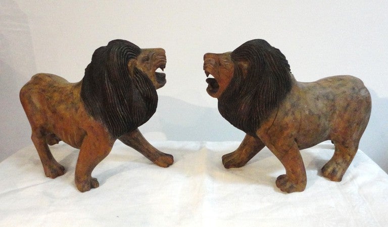 Fantastic hand carved and painted lions in wonderful surface & patina.The carvings are very good and are all wood.The surface is a dry ,flat painted surface.