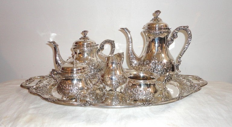 Fantastic signed sterling & Handerbeit silver six piece tea set.This amazing complete tea service is in pristine condition and weighs 2078 grams.This set has no dents or damages.It has a wonderful rococo floral pattern embossed through out.Sold as a