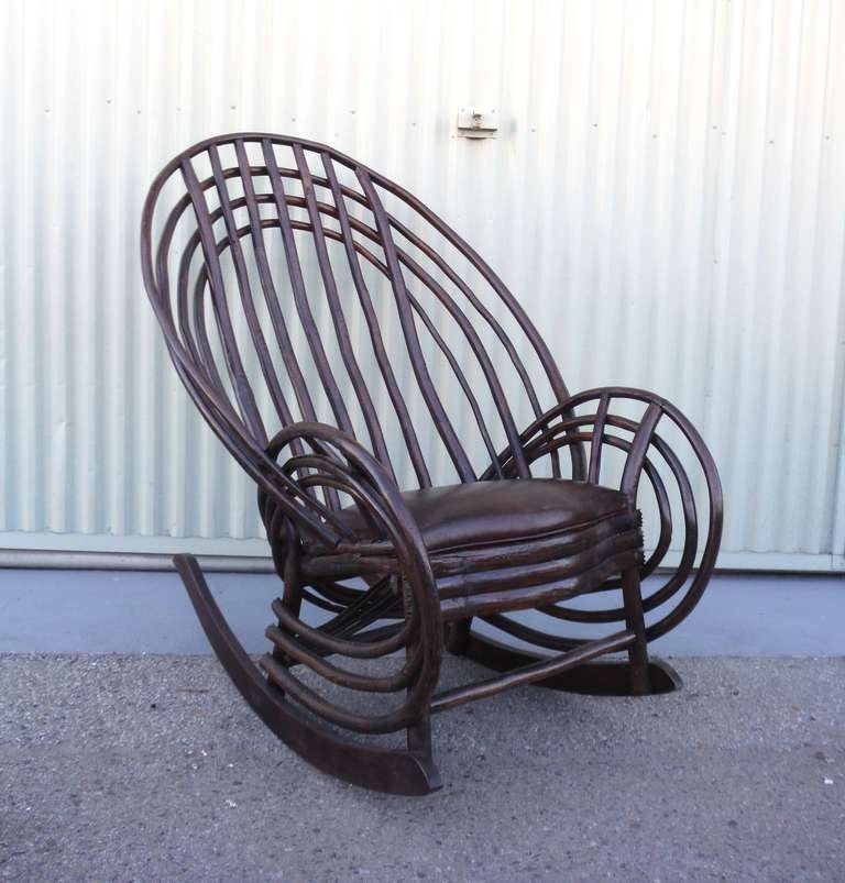 This 19th century mid-western barrel back bentwood twig rocker is strong, sturdy and remarkably comfortable.  The chair is constructed from hand-crafted and chip carved hickory with a newly upholstered brown leather seat and also shows square nail