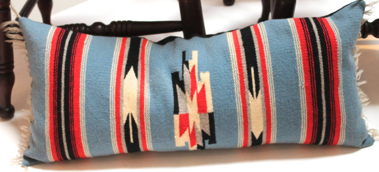 This Mexican Indian weaving bolster pillow has a great geometric pattern. The weaving has it's original fringe and a black linen backing. The insert is down and feather fill.