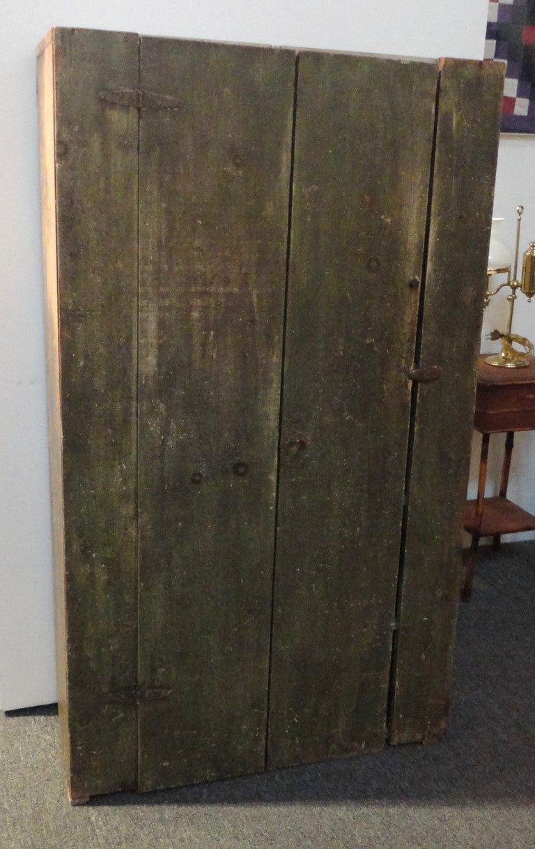 19th century original green painted wall cupboard has a wonderful surface paint. The color is a sage green over white washed paint with an interior white washed painted group of five shelves. This wonderful jam or wall cupboard was found in a