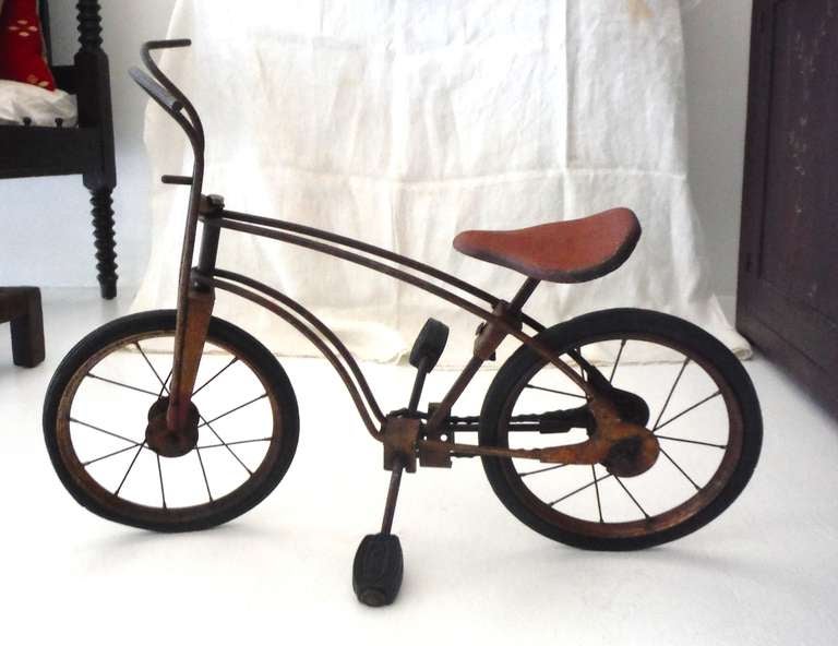 Early original painted surface MOBO child's bike. This folky bike has the original signed rubber pedals  and tires .It is signed Made In England and is in great working condition . It is made in 1926 .